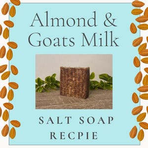 Puede incluir: Una pastilla de jabón de sal rectangular, marrón y texturizada, centrada sobre un fondo azul claro. El texto "Almond & Goats Milk" aparece en la parte superior y "SALT SOAP RECPIE" en la inferior. El borde está decorado con almendras.