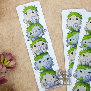 May include: A white ceramic mug with a black handle and the text "But First, Coffee" in a black, handwritten-style font. The mug is on a white surface.