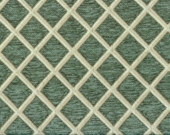 Puede incluir: Una tela verde con un patrón de diamantes blancos. La tela tiene una superficie texturizada.