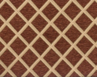 Puede incluir: Una tela de color marrón y beige con un patrón de diamantes. La tela tiene una superficie texturizada.