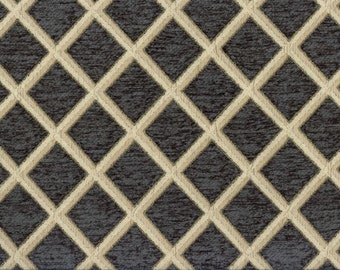 Puede incluir: Una tela gris oscura con un patrón de diamantes beige. La tela tiene una superficie texturizada.