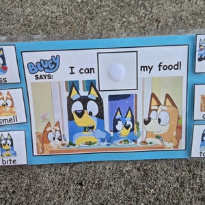 May include: A Bluey-themed learning aid with a blue border. The card features illustrations of Bluey characters and the phrase "I can my food!" with associated actions like "kiss," "smell," "bite," "lick," "chew," and "touch."
