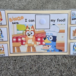 May include: A Bluey-themed Bingo game with illustrations of the characters. The game includes the text "BINGO SAYS: I can my food!" and images with words like "kiss", "bite", "smell", "lick", "chew", and "touch".