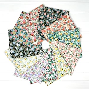 May include: A collection of floral fabric swatches arranged in a circular pattern. The fabrics feature various floral designs in shades of pink, blue, green, and yellow on a white background. The fabrics are made of cotton.
