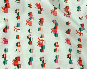 May include: Mint green fabric with a repeating pattern of stacked presents in red, pink, white, and green. The fabric has the text "Christmas in the Cabin" and "AGF Studio" printed on it.