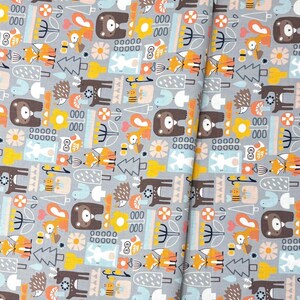 May include: Gray fabric with a repeating pattern of woodland animals and trees in brown, orange, yellow, and blue. The design includes bears, foxes, owls, and hedgehogs. The fabric has a whimsical, cartoon-like style.