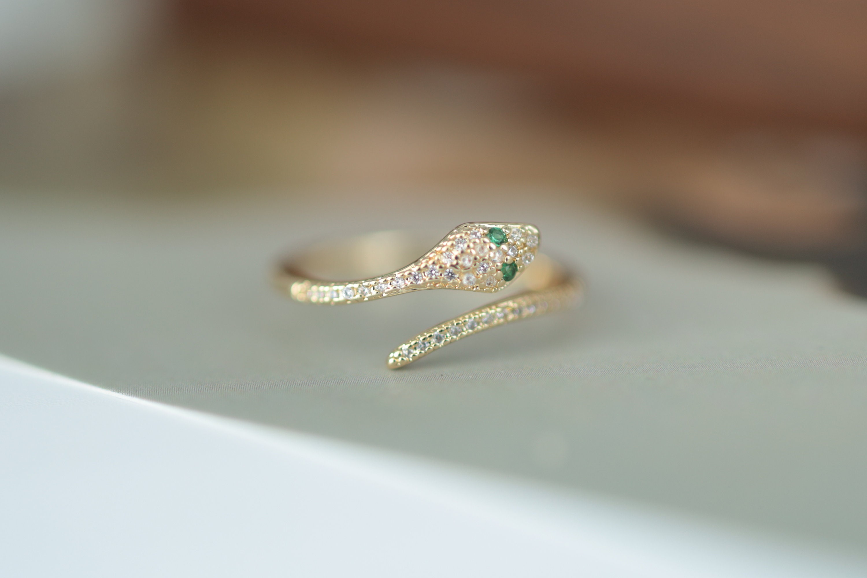 Snake ring with green on sale eyes