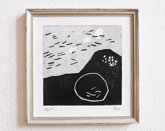 May include: Abstract black and white art print in a distressed silver frame. The print depicts a landscape with a large, rounded shape, a mountain, and various shapes in the sky. Signed "PK '24" and numbered 1/60.