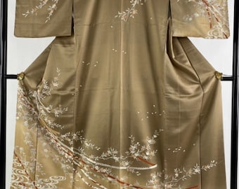 May include: A traditional Japanese kimono with a gold background and intricate white and red floral embroidery. The kimono features a flowing design with delicate branches and blossoms.