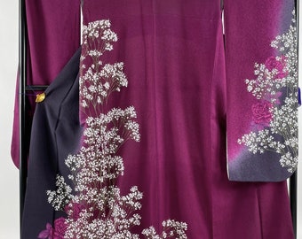May include: A purple silk kimono with a white floral pattern. The kimono has a dark purple lining and a white floral design on the sleeves.