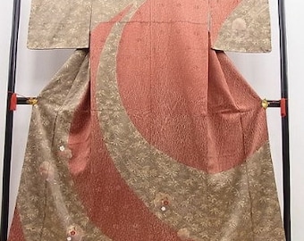 May include: A traditional Japanese kimono with a brown and red pattern. The kimono is made of silk and has a geometric design with curved lines and circles.