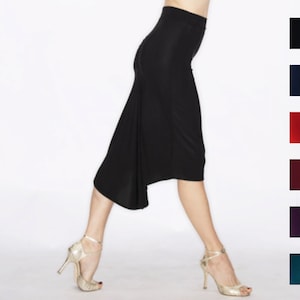 May include: A black skirt with a high waist and a flowing asymmetrical hemline. The skirt is made of a soft, stretchy fabric and is ideal for dancing or evening wear.