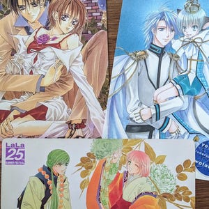 Könnte beinhalten: Drei farbenfrohe Anime-Kunstdrucke. Der obere linke Druck zeigt ein sich umarmendes Paar, der obere rechte Druck zeigt zwei Charaktere in aufwendiger Kleidung und der untere Druck zeigt zwei Figuren in traditioneller Kleidung.