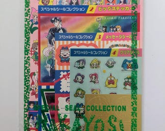 May include: A collection of colorful stickers featuring anime characters, packaged in a clear plastic sleeve. The stickers have various designs, including images of Sailor Moon characters and other anime-style illustrations. The package includes Japanese text.