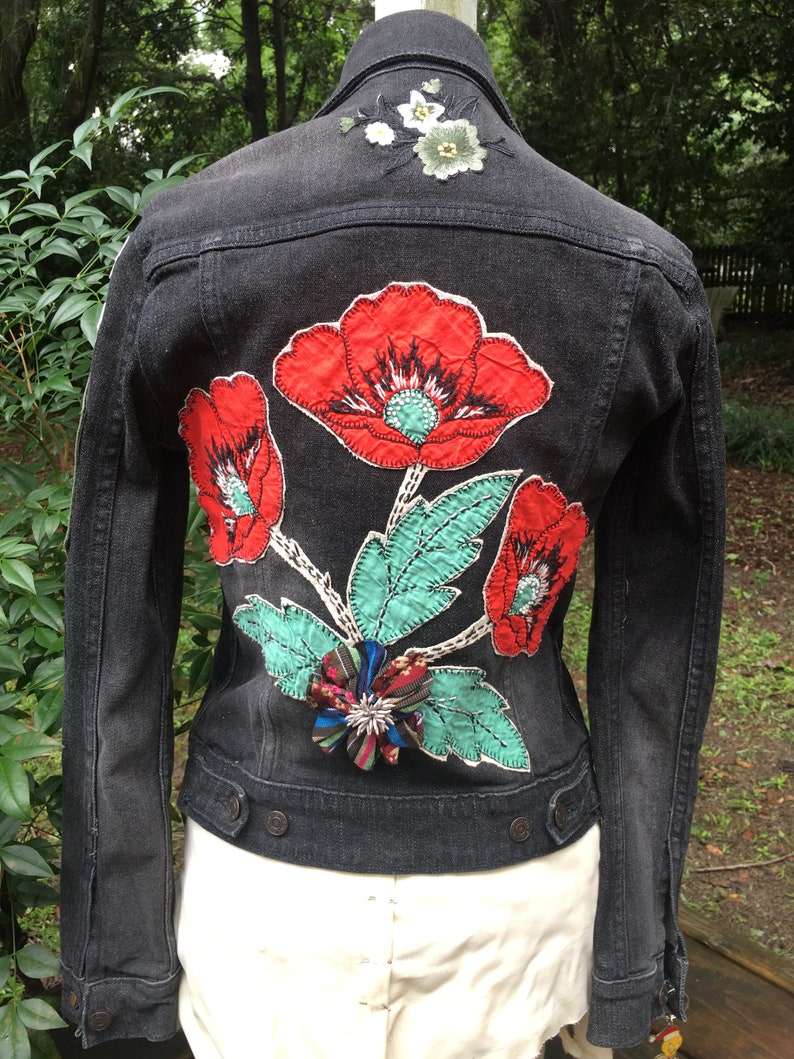 vintage patches pins and jewelry assemblage upcycled JEAN JACKET with antique needlework flowers