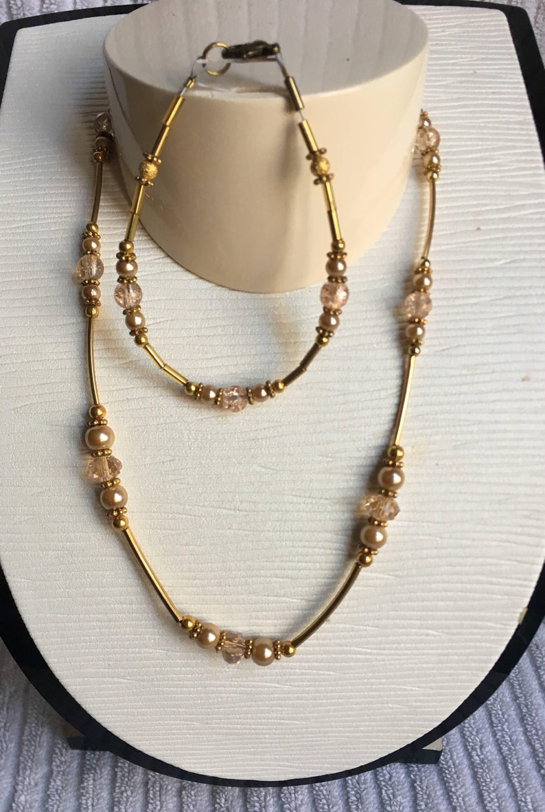 Crystal Classic Beauty and Pearl Necklace and Bracelet Set \u2013 Elegant and Timeless Decadent Gold
