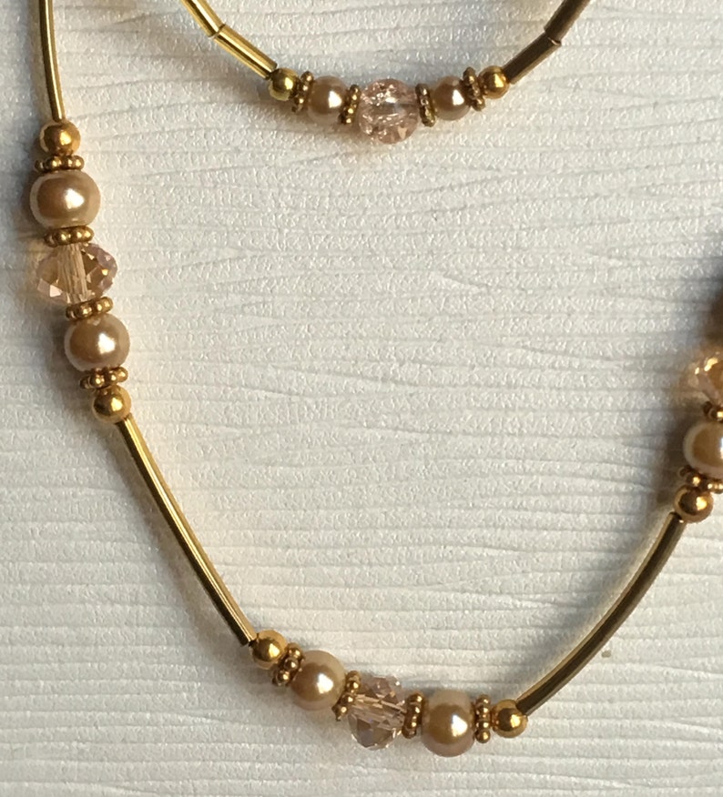 Crystal Classic Beauty and Pearl Necklace and Bracelet Set \u2013 Elegant and Timeless Decadent Gold