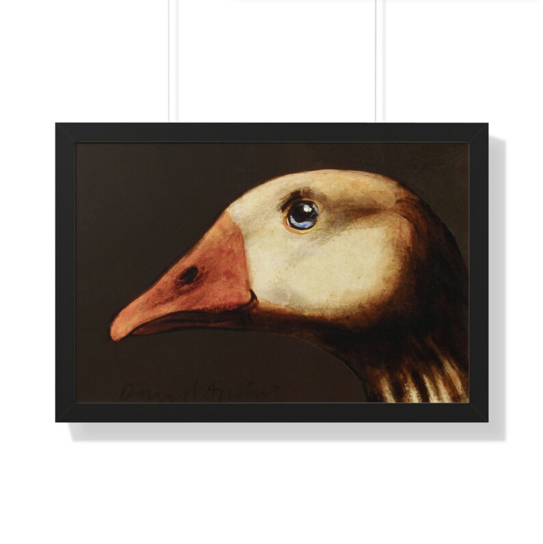 May include: Framed artwork featuring a detailed painting of a goose's head in profile. The goose has a cream-colored head, a reddish-orange beak, and a blue eye. The artwork is set against a dark background and framed in black.