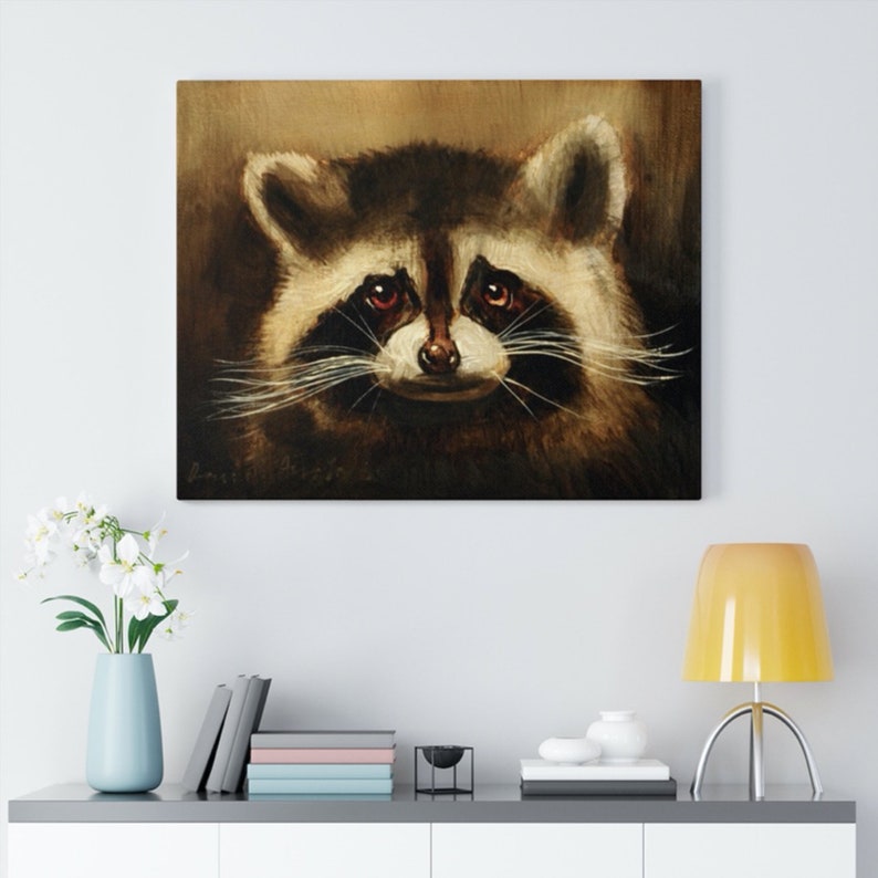 May include: A close-up painting of a raccoon's face. The raccoon has dark brown fur, a black nose, and black eyes. The background is a muted brown color.