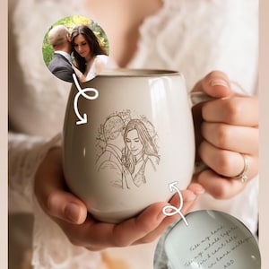 May include: A beige ceramic mug featuring a brown line-art illustration of a couple on the front. A circular inset shows the original photograph used for the drawing. A second inset displays the interior bottom with the text: Take my hand, take my whole life too, for I can't help falling in love with you, A&D.