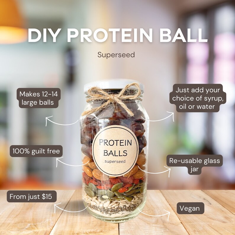 May include: A glass jar filled with ingredients for making protein balls, including dates, almonds, pumpkin seeds, goji berries, and chia seeds. The jar has a label that reads "PROTEIN BALLS superseed". The image also includes text that says "DIY PROTEIN BALL Superseed", "Makes 12-14 large balls", "100% guilt free", "From just $15", "Just add your choice of syrup, oil or water", "Re-usable glass jar", and "Vegan".