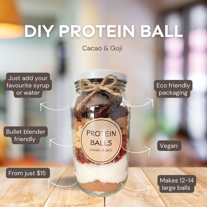 May include: A glass jar filled with ingredients for making protein balls. The jar is labeled "PROTEIN BALLS cacao & goji". The ingredients include dates, almonds, goji berries, coconut flakes, and cacao powder. The jar is tied with twine and a tag. The text on the image reads "DIY PROTEIN BALL Cacao & Goji", "Just add your favourite syrup or water", "Bullet blender friendly", "From just $15", "Eco friendly packaging", "Vegan", "Makes 12-14 large balls".