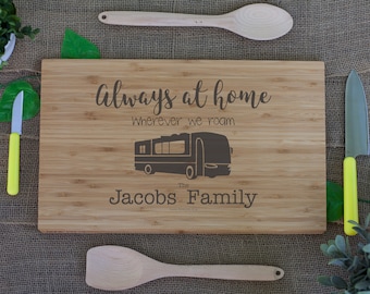 May include: A brown wooden cutting board with the text "Always at home Wherever we roam" and a silhouette of a camper van. The text "The Jacobs Family" is also engraved on the board.