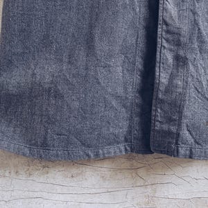 May include: A dark gray denim skirt with a button closure. The skirt has a straight silhouette and a simple design.