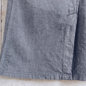 May include: A dark gray denim skirt with a seam down the front.