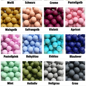 Könnte beinhalten: Eine Sammlung von 16 Silikon-Beißringen in verschiedenen Farben, darunter Weiß, Schwarz, Creme, Gelb, Gold, Orange, Lila, Rosa, Hellblau, Dunkelblau, Grün und Grau. Die Beißringe sind in Form von kleinen Kugeln mit einer strukturierten Oberfläche.