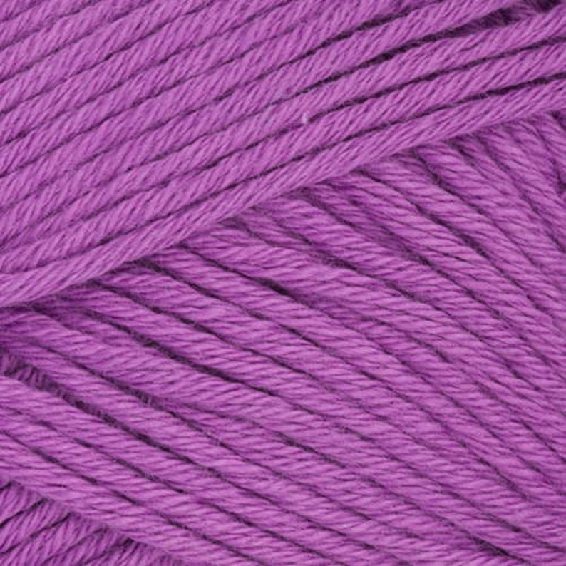May include: A skein of purple yarn. The yarn is soft and fluffy, and it is perfect for knitting or crocheting.
