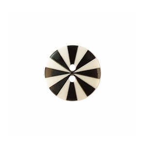 May include: A round, two-hole button featuring a high-contrast, radial sunburst pattern of alternating black and white triangular segments that converge at the center, creating a geometric design across the entire surface of the circular fastener.