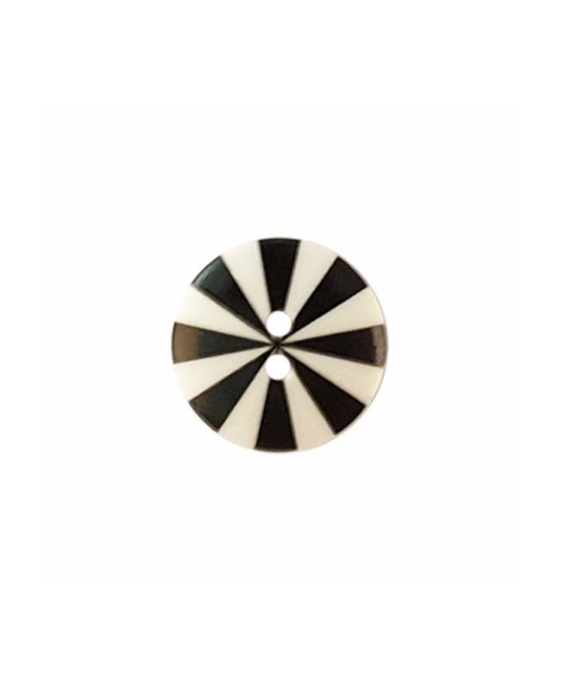 May include: A round, two-hole button featuring a high-contrast, radial sunburst pattern of alternating black and white triangular segments that converge at the center, creating a geometric design across the entire surface of the circular fastener.