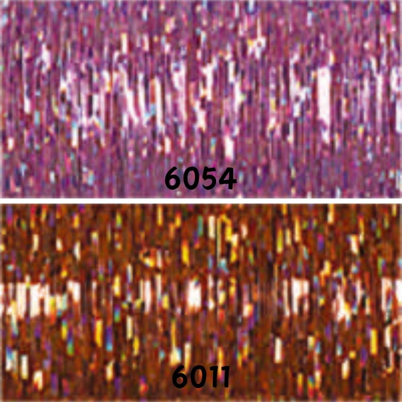 May include: Two rolls of iridescent metallic streamer, one purple and one brown. The purple roll is labelled "6054" and the brown roll is labelled "6011".