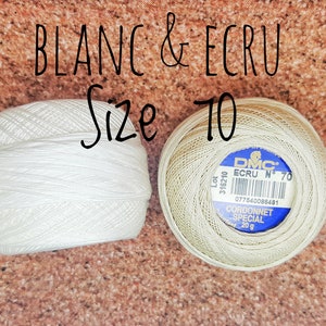 May include: Two spools of DMC Cordonnet Special embroidery floss, one white and one ecru, labeled "Size 10". The ecru spool has the DMC logo and the text "ECRU N&deg; 70" and "Lot 316210".