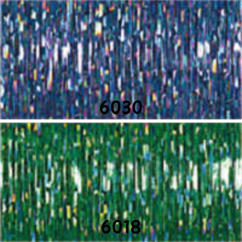 May include: Two rolls of iridescent metallic streamer, one blue and one green. The blue roll has the number 6030 printed on it, and the green roll has the number 6018 printed on it.