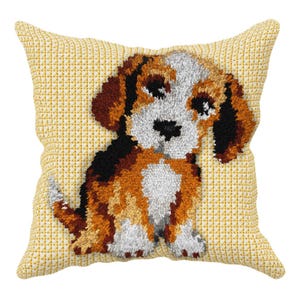 May include: A decorative throw pillow featuring a detailed, embroidered image of a beagle puppy. The puppy has brown, black, and white fur, with a black nose and eyes. The pillow has a yellow background and a textured appearance.