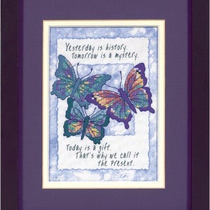 May include: Framed art print with a blue background and three colourful butterflies. The print features the text "Yesterday is history. Tomorrow is a mystery. Today is a gift. That's why we call it the present."