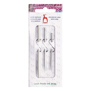 May include: A set of three white knitting needles in a plastic package. The package has the text "Wool Needles, Aiguilles Laine, Wollnadeln, Agujas de Lana, Aghi Lana" and "create beauty with PONY".