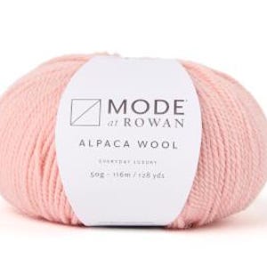 May include: A ball of pale pink alpaca wool yarn with a white label that reads "MODE at ROWAN ALPACA WOOL EVERYDAY LUXURY 50g - 116m / 128 yds"