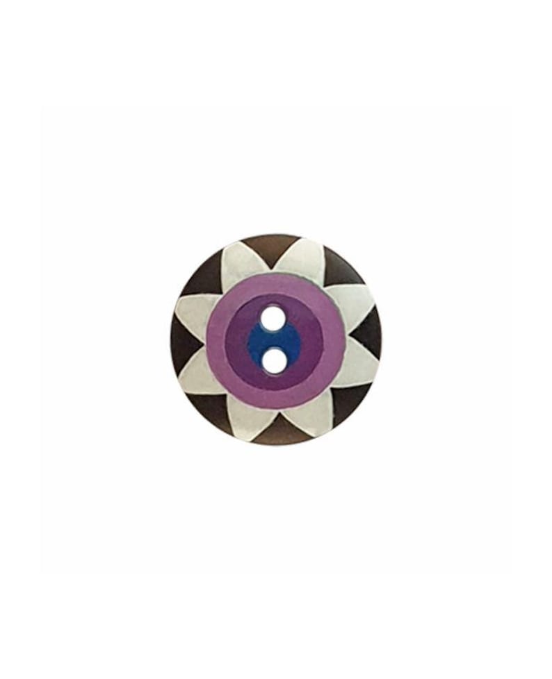 May include: A round, two-hole button featuring a dark brown outer edge, a white petal-like pattern, a lavender ring, and a dark blue center. The design is symmetrical, with the white petals radiating from the center toward the outer brown border.