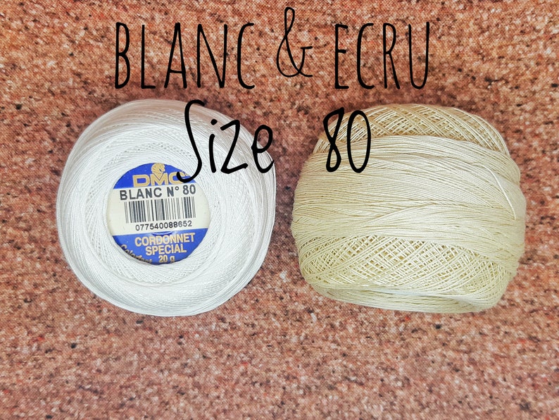 May include: Two spools of DMC embroidery floss, one white and one ecru, both labeled "Blanc N&deg; 80" and "Cordonnet Special 20g".