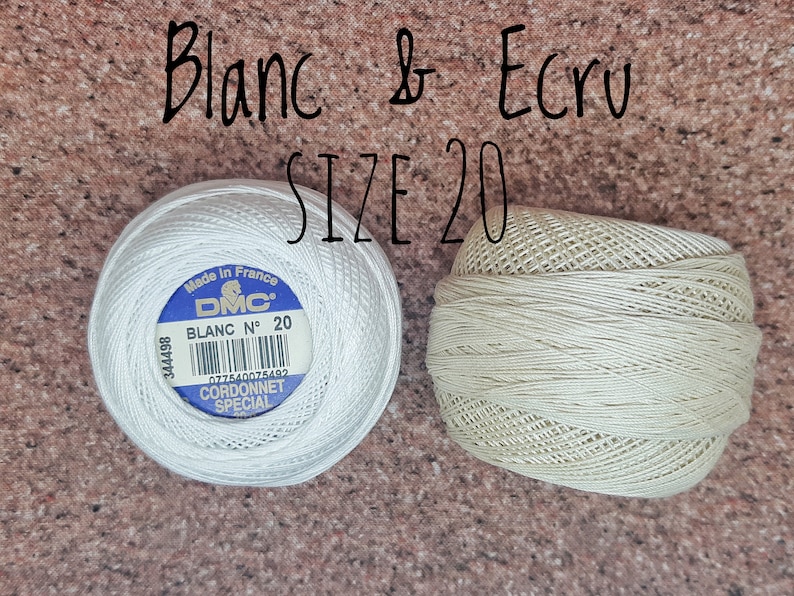 May include: Two spools of DMC embroidery floss, one white and one ecru, both size 20. The white spool has a blue label with the text "Made in France DMC BLANC N&deg; 20 077840075402 CORDONNET SPECIAL".