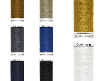 May include: Eight spools of Gütermann Denim thread in various colors, including gold, gray, blue, dark blue, black, and white. Each spool is labeled with the brand name and the length of the thread in yards and meters.