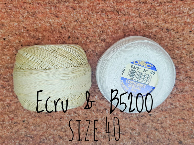 May include: Two spools of DMC Cordonnet Special embroidery floss. One spool is white and labeled B5200 No. 40. The other spool is ecru and labeled B5200. Both spools are size 40.