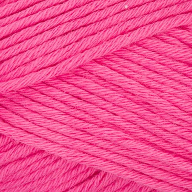 May include: Close-up of a bright pink yarn skein. The yarn is soft and fluffy, perfect for knitting or crocheting.