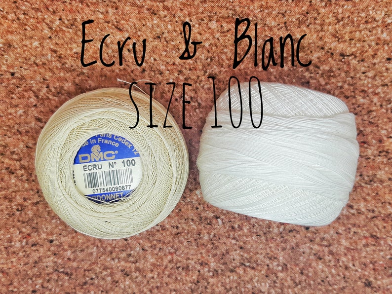 May include: Two spools of DMC embroidery floss, one in ecru and one in white. Both spools are size 100.