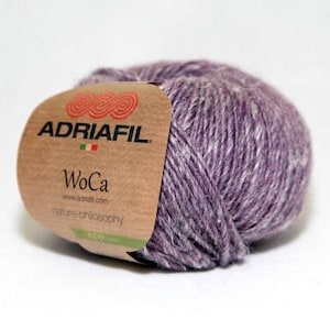 May include: A skein of purple yarn with a brown label that reads "ADRIAFIL WoCa nature-philosophy eco".