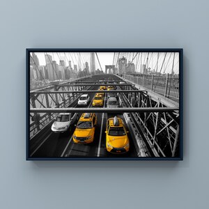May include: A black and white photo of yellow taxis driving across the Brooklyn Bridge in New York City. The bridge is made of steel and has a lot of intricate details. The taxis are all facing the same direction and are driving in a line.