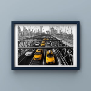 May include: A black and white photo of yellow taxis driving across a bridge in New York City. The bridge is made of metal and has a lot of support beams. The taxis are all in a line and are driving in the same direction. The city skyline is visible in the background.
